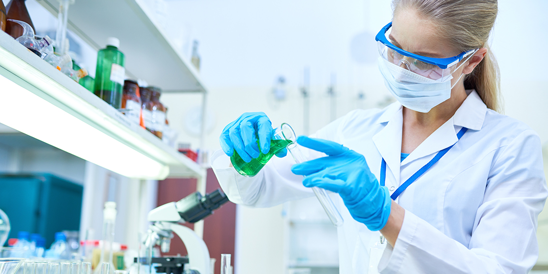 female scientist pouring liquids in laboratory