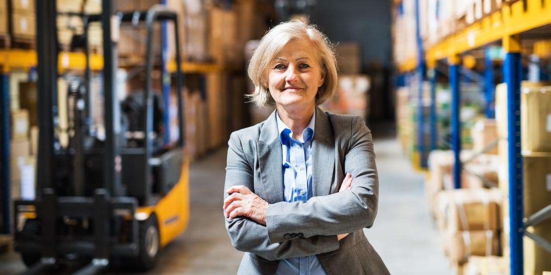 Inventory Management senior woman warehouse manager or supervisor arms